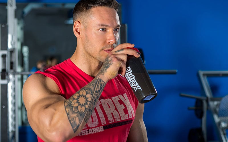 Nutrex Athlete Drinking out of Blender Bottle