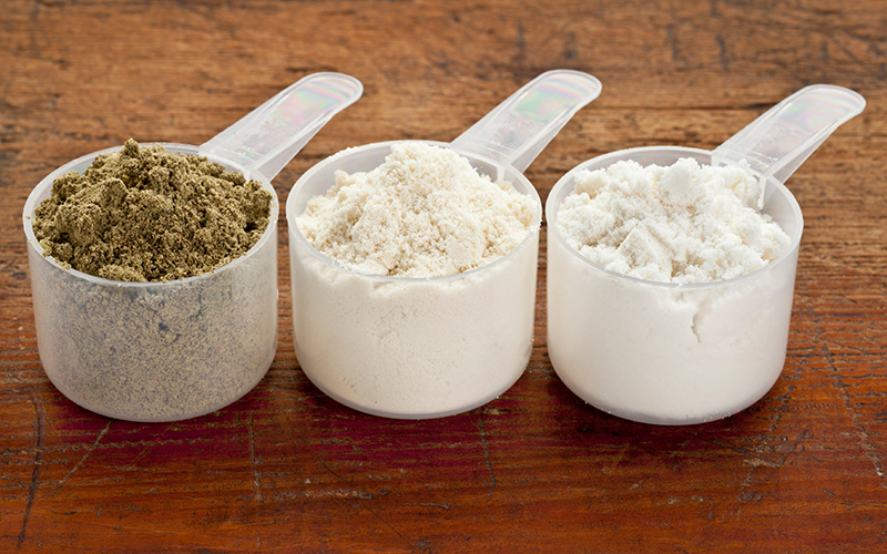 4 Ways To Save Money On A Muscle Building Diet - different scoops of protein