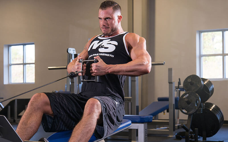 Guy performing cable rows for bulking season