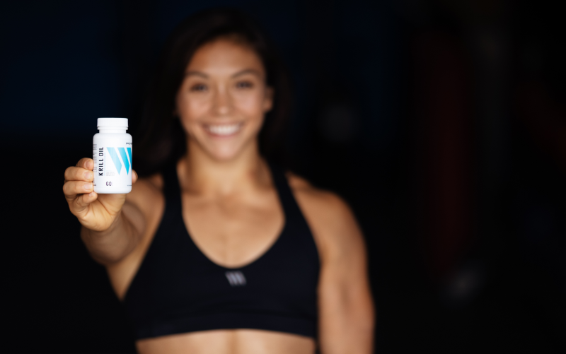 Swolverine athlete holding Krill Oil bottle