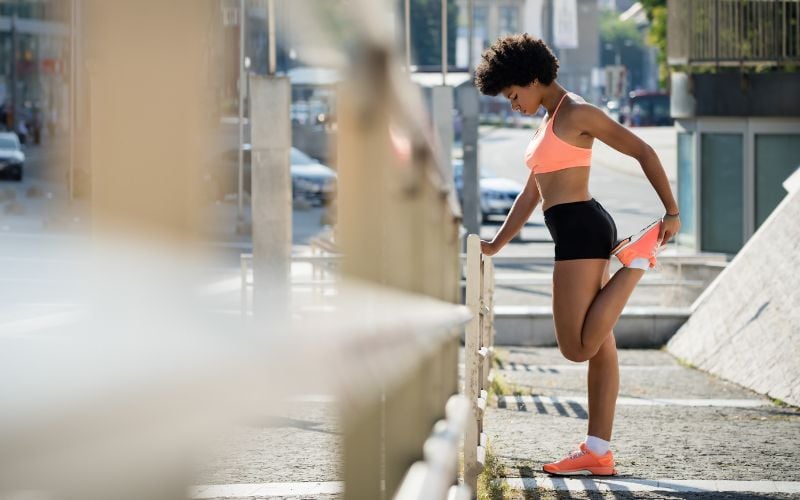 Fit African American woman getting ready to jog outside.