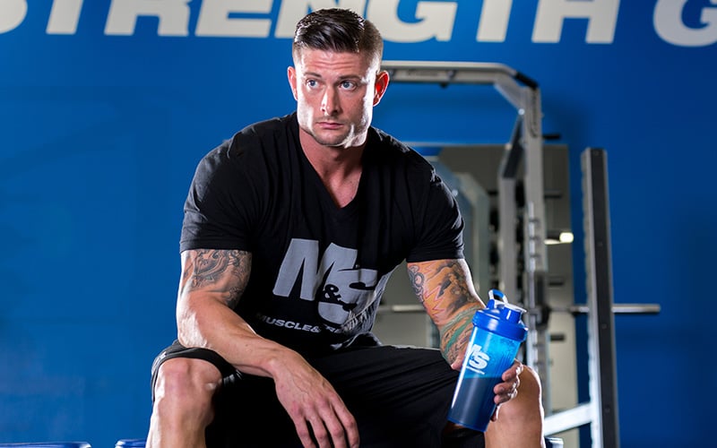 Man Sitting and Drinking Protein