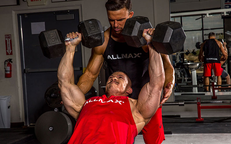 Allmax athletes spotting each other