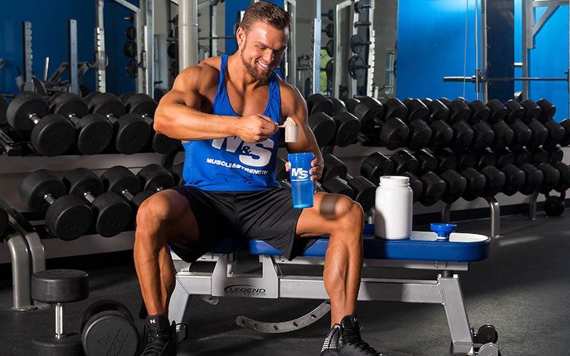 How much protein should you ingest post workout? Guy taking a large scoop