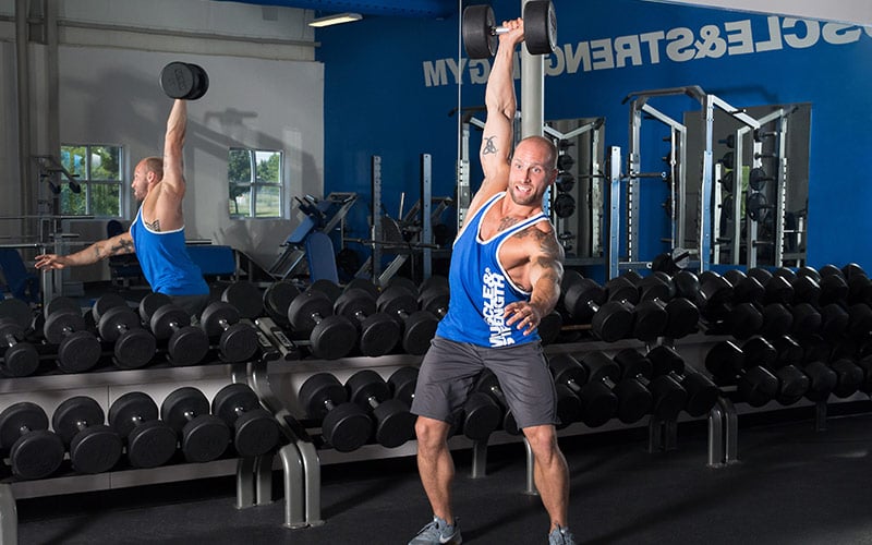Muscle & Strength Athlete Doing Single Arm Dumbbell Thrusters