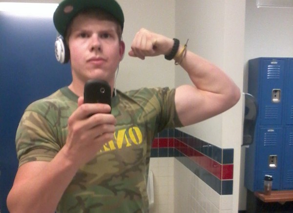 Matthew Braden flexing his biceps