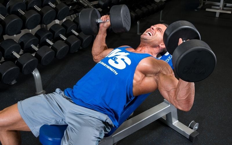 Muscle & Strength Athlete Doing Chest Presses in the Gym