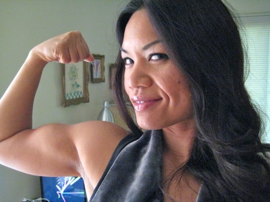 Mitchie De Leon flexes her bicep.