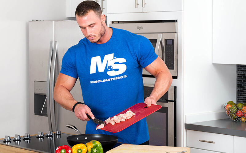 M&S Athlete Cooking Food in the M&S Kitchen While Wearing a M&S Shirt