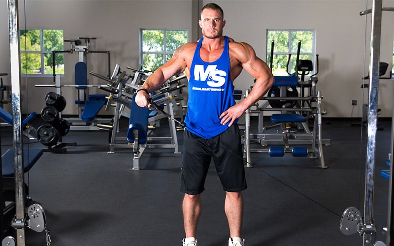 Muscle & Strength Athlete Using Cables for Shoulder Workout
