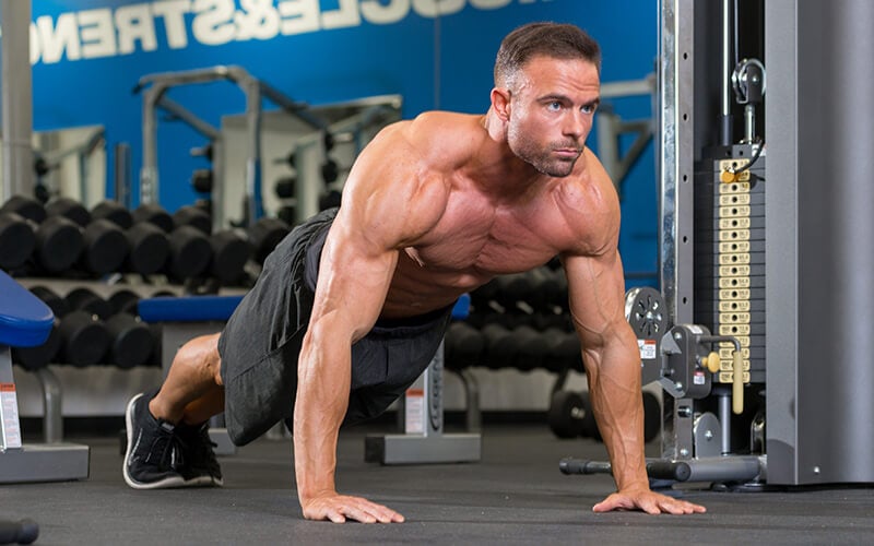 Dymatize athlete doing planks from pushup position